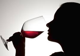 Woman drinking a glass of red wine
